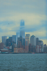 Obraz premium Iconic One World Trade Center Piercing Foggy Clouds with Copy Space