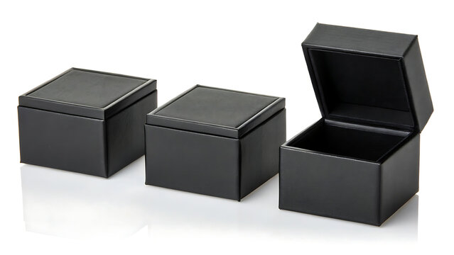 Three elegant black leather gift boxes with lids open on white background