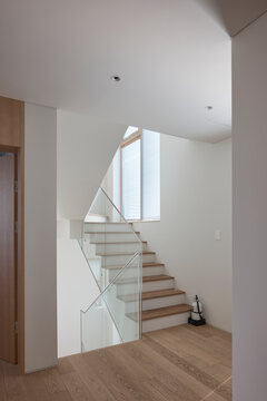 Open stair and bright foyer in minimalist white home