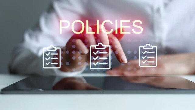 Business person working on policies and checking tasks on a digital tablet in an office setting during daytime.