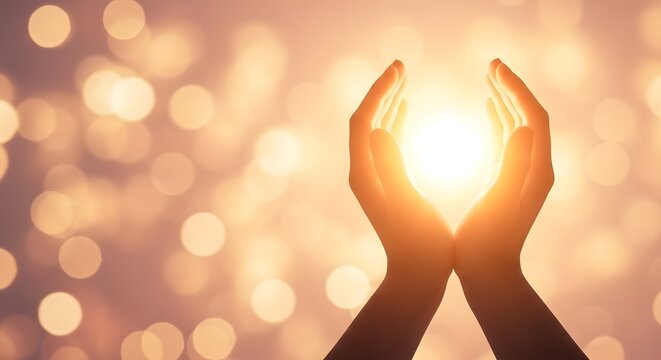 Hands reaching up towards bright light with bokeh effect cupped hands reaching