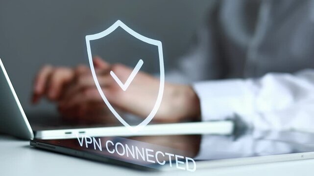 Working on a laptop with a VPN connection displayed on the screen in an office setting during the day.