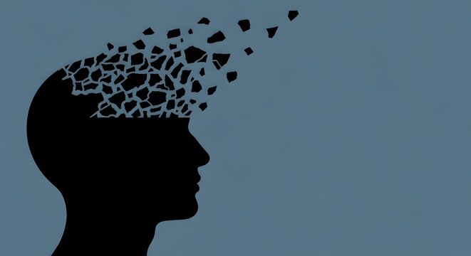 Silhouette of a man's head with fragmented pieces breaking away, memory loss