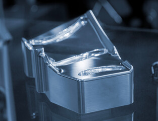 Metal part manufactured using CNC machining. Metal part made by metalworking CNC machine from a solid piece of metal. Polished aluminum or stainless steel. High-precision milling followed by polishing © mari1408