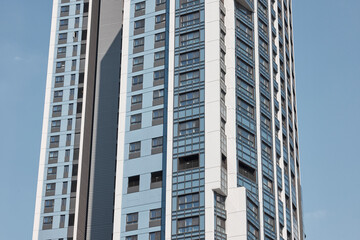 Fototapeta premium Close apartment tower facade under clear daylight