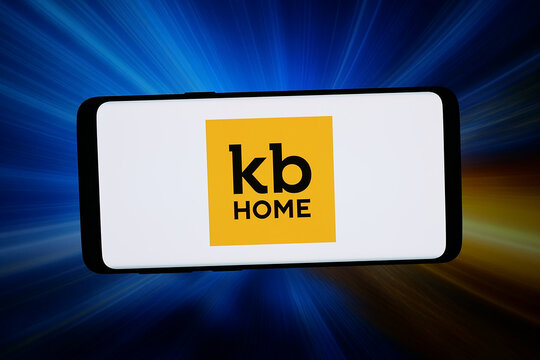 Stuttgart, Germany - 03-31-2026: In this photo illustration, the logo of US homebuilding company KB Home is displayed on a smartphone in front of abstract background on computer screen.