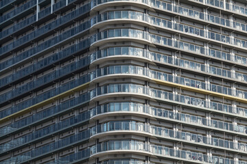 Close crop of curving apartment balconies in high rise facade © Namsun
