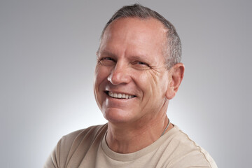 Fototapeta premium Happy, creative and man with portrait in studio for career pride, about us and journalist. Mockup space, mature person and smile with profession ambition, copywriting experience and white background