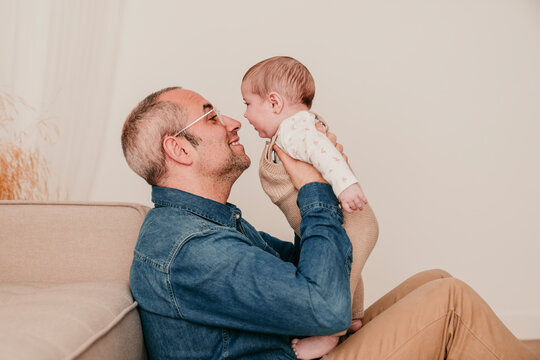 Father hugging baby at home showing love and bonding