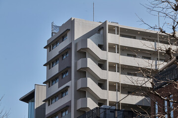 Mid rise residential block under clear sky in urban neighborhood © Namsun