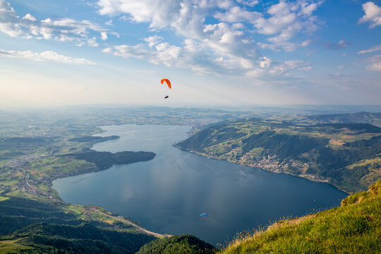 Paraglider flying over Lake Zug from summit of Mount Rigi Switzerland