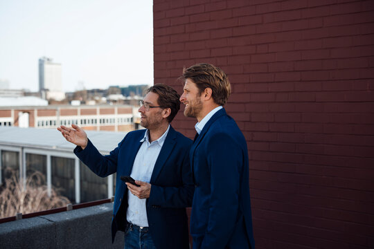 Businessmen discussing strategy and cooperation outdoors