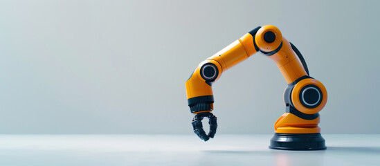 Minimalist stock photo of a single yellow and black industrial robotic arm on a clean light grey background, modern automation and manufacturing concept with generous copy space, sharp product focus