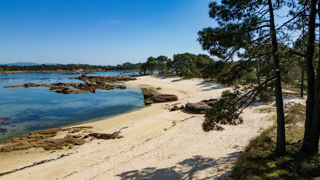  White sand beach and granite rocks in Illa de Arousa, Galicia