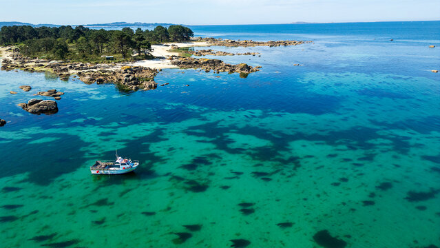 Fishing boat in turquoise waters of Illa de Arousa, Galicia