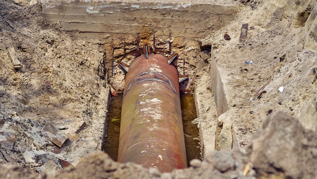 Sewerage.Dug hole with metal water sewer pipes for repair,replacement