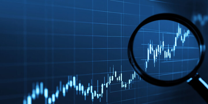 A magnifying glass scrutinizes a blue digital financial stock market chart displaying upward and downward trends