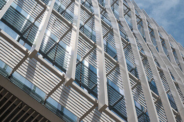 Obraz premium Facade detail of white sun screen and window grid against blue sky