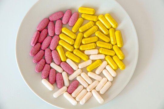 Pills arranged neatly on a white plate