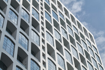 White facade with repetitive arched balconies in sunlight © Namsun