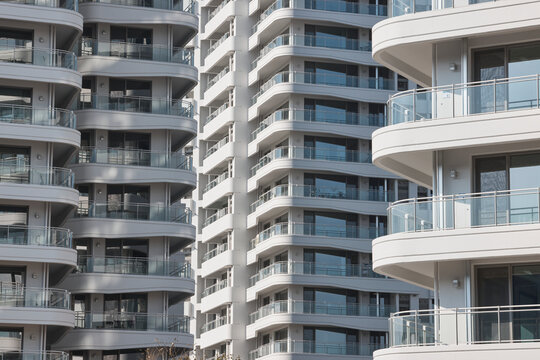 Rounded residential tower facade with stacked balconies