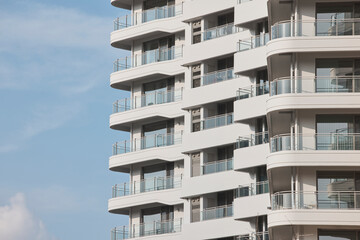 Rounded apartment balconies under clear blue sky © Namsun