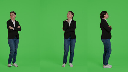 Obraz premium Impatient office worker waiting and being late, standing over full body green screen background. Young businesswoman wait, wearing suit on studio isolated greenscreen backdrop.