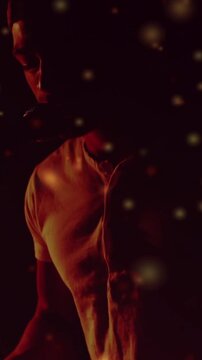 Vertical video: Singer leaning into mic, singing as warm backlight and drifting bokeh framing music