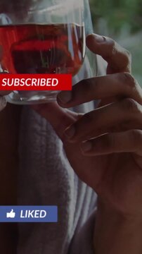 Vertical video: Hands cradling amber tea, doublewalled cup while social alerts popping placing down