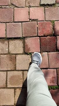 Walking on a brick path for fitness, a healthy living concept. Personal point of view POV