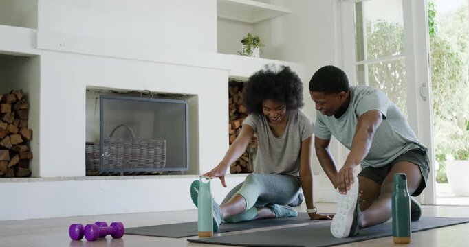 Man and woman starting routine kneeling, extending legs, stretching hamstrings on mats for fitness