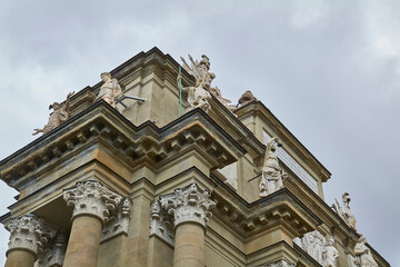 Fototapeta premium Ornate baroque church facade detail against gray sky