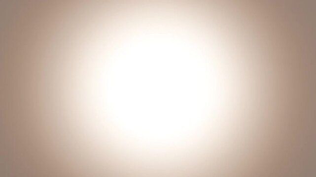 Soft focus photography of a bright white light against a beige background with a gradient effect.