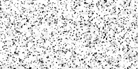 Fototapeta premium Black and white terrazzo texture seamless pattern with dark stone chips on light marble. A densely speckled abstract texture with varying shades of gray and black against a white background