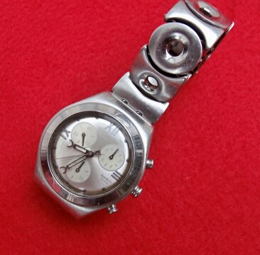 Swatch Irony stainless steel chronograph watch on red background