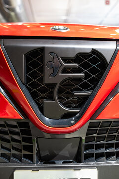 Zurich, Switzerland, October 10, 2025. Close-up of the scudetto grille on an Alfa Romeo Junior at an indoor automotive exhibition