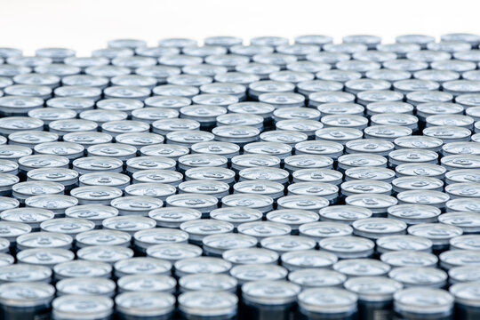 Stack of aluminum beer cans forming repetitive industrial