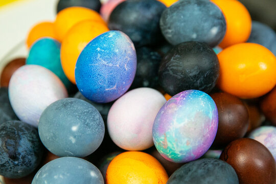 Colorful dyed Easter eggs in glass bowl &ndash; traditional holiday decoration