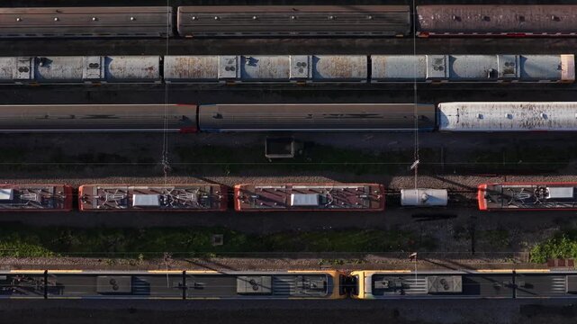 Aerial view of train depot with an array of wagons displaying varied colors, textures and tones, highlighting the urban landscape, Porto, Portugal.