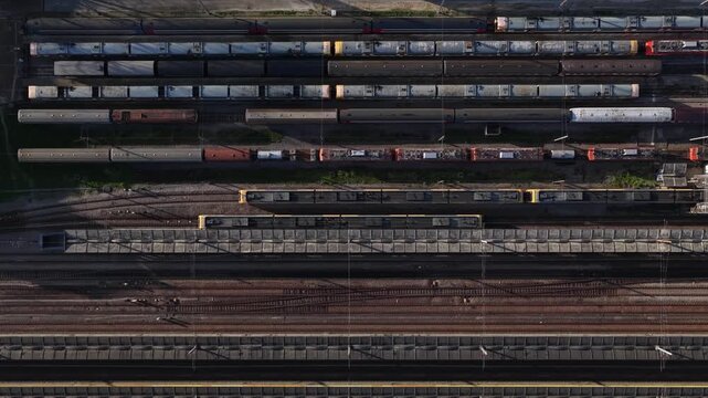 Aerial view of an expansive train yard with parallel tracks and parked train cars, showcasing the organized chaos of railway infrastructure, Porto, Portugal.