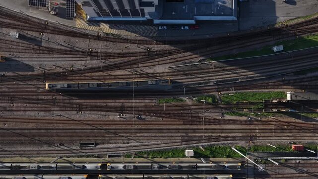 Aerial view of rail tracks forming an intricate pattern, intersecting and converging, showcasing the city's transport network, Porto, Portugal.
