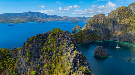 Aerial view of a beautiful tropical island with crystal clear water with limestone cliffs as the beach, Coron, Palawan, Philippines. © SASITHORN