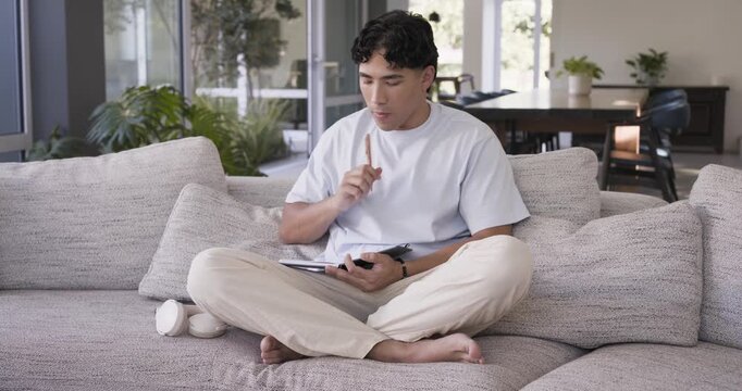 Camera is slowly moving closer while pen is writing in notebook on gray sofa for planning