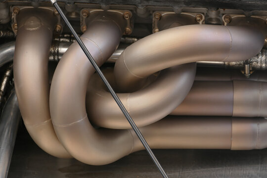 Chichester, United Kingdom - 21 July 2018: View of the exhaust manifold with its complex curves and metallic sheen, reflecting light and heat in a symphony of engineering precision.