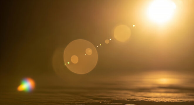 Golden sunset over ocean with light leaks and film burn effects, abstract background with glow