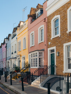 London, United Kingdom - 21 June 2025: View of a row of houses painted in pastel shades, their vibrant facades creating a cheerful streetscape.