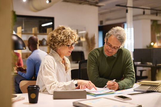 Business people discussing on documents and business reports