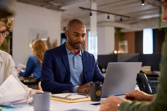 African american businessman working on laptop in modern office