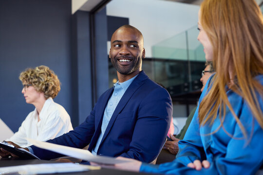 Successful black businessman smiling to businesswoman at business conference