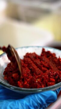 Vertical Close Up of Spicy Turkish Cemen Paste Being Put Into a Small Bowl